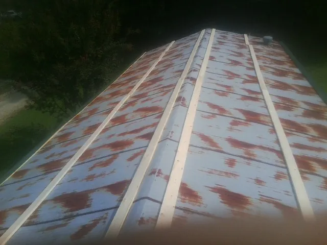 Rusted metal roof panels with new wood purlins before replacement — Storm Damage Roof Repair in Avenel by Roofing Brothers