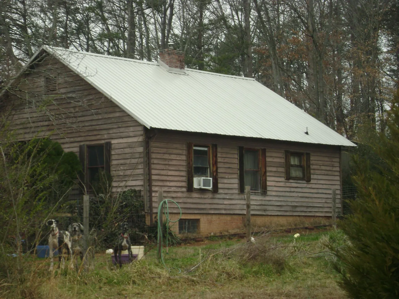 White metal roof on an old wood sided farmhouse, from a Metal Roof Installation job in Avenel